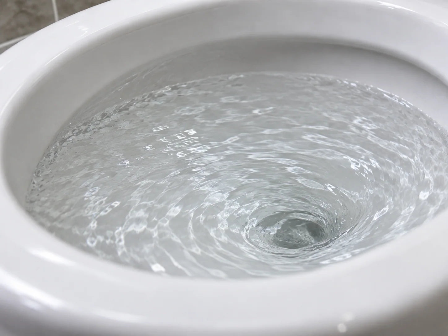 Illustrative clear water draining during a household toilet flush